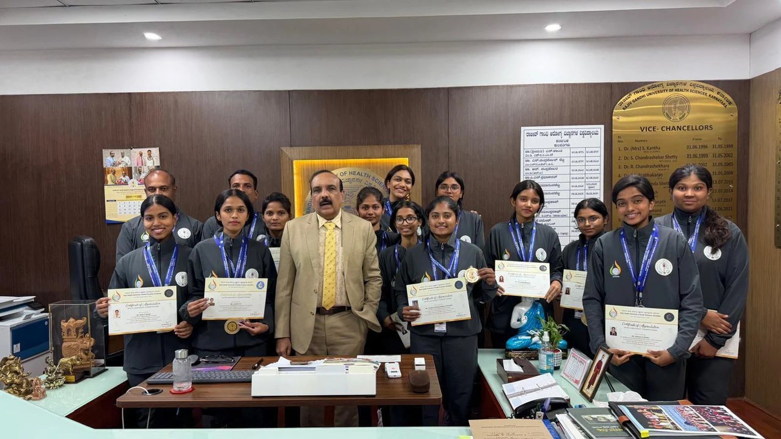 RGUHS Vice-Chancellor Bhagawan B. C. with Netball players holding medals and University Blue Honour certificates at RGUHS Bengaluru felicitation ceremony