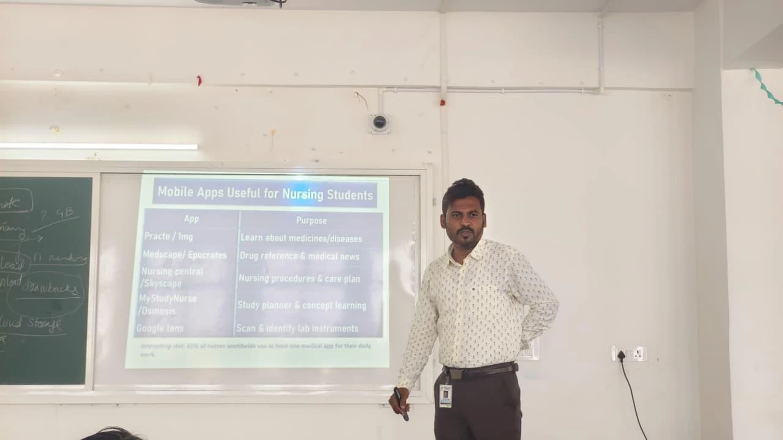 Resource person presenting technical session on Mobile Apps Useful for Nursing Students at Workshop on Digital Literacy for Health Care BLDEA College of Nursing Jamkhandi projector screen showing apps table with Practo IMing Medscape SkyScape NursesMate November 10 2025