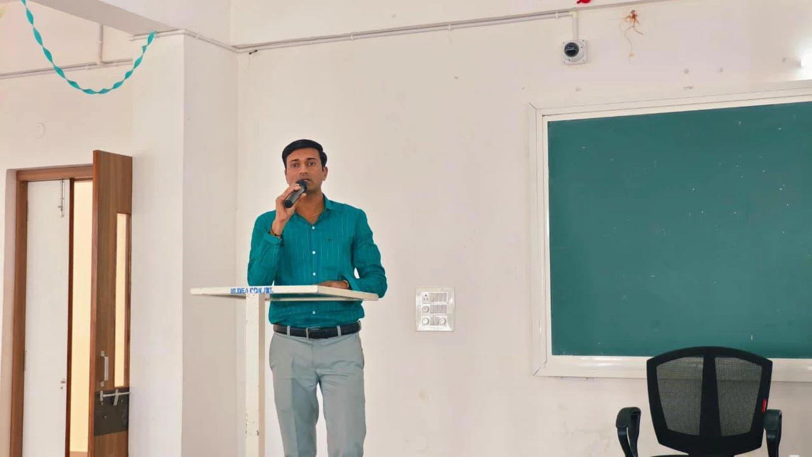 Mr Santosh Umadi Assistant Professor BLDEA Commerce BHS Arts TGP Science College Jamkhandi delivering address at podium during Workshop on Digital Literacy for Health Care BLDEA College of Nursing Jamkhandi November 10 2025