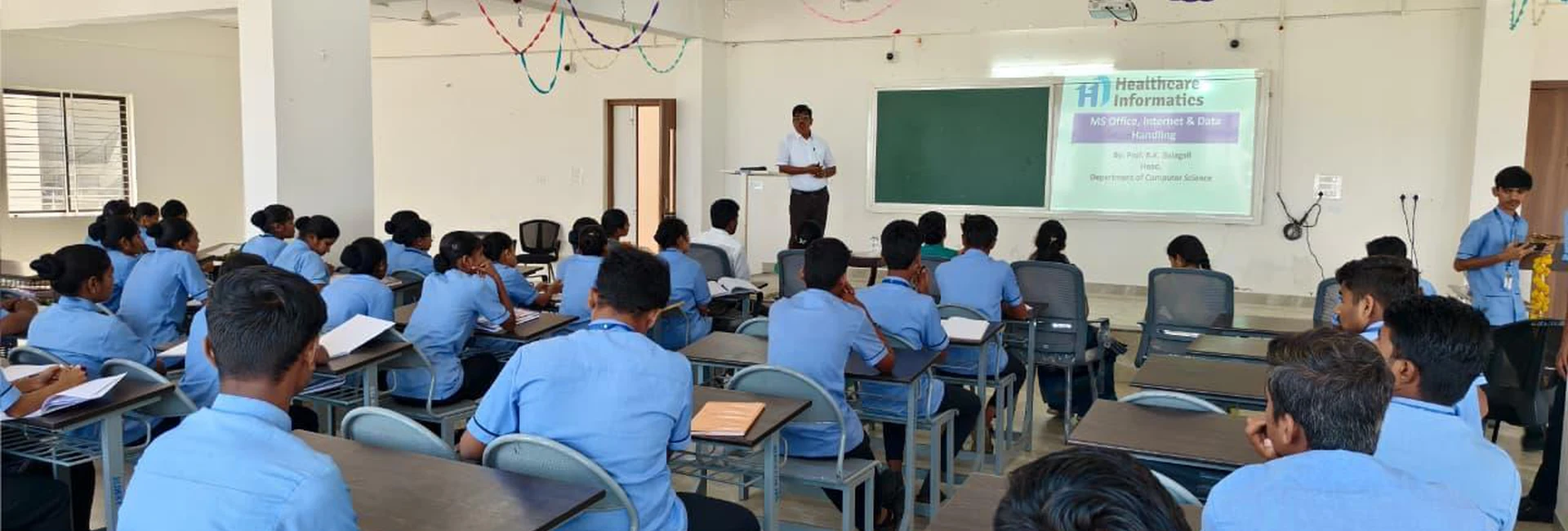 Second Semester BSc Nursing students in blue uniforms attending Workshop on Digital Literacy for Health Care at BLDEA College of Nursing Jamkhandi Seminar Hall with resource person presenting at front November 10 2025