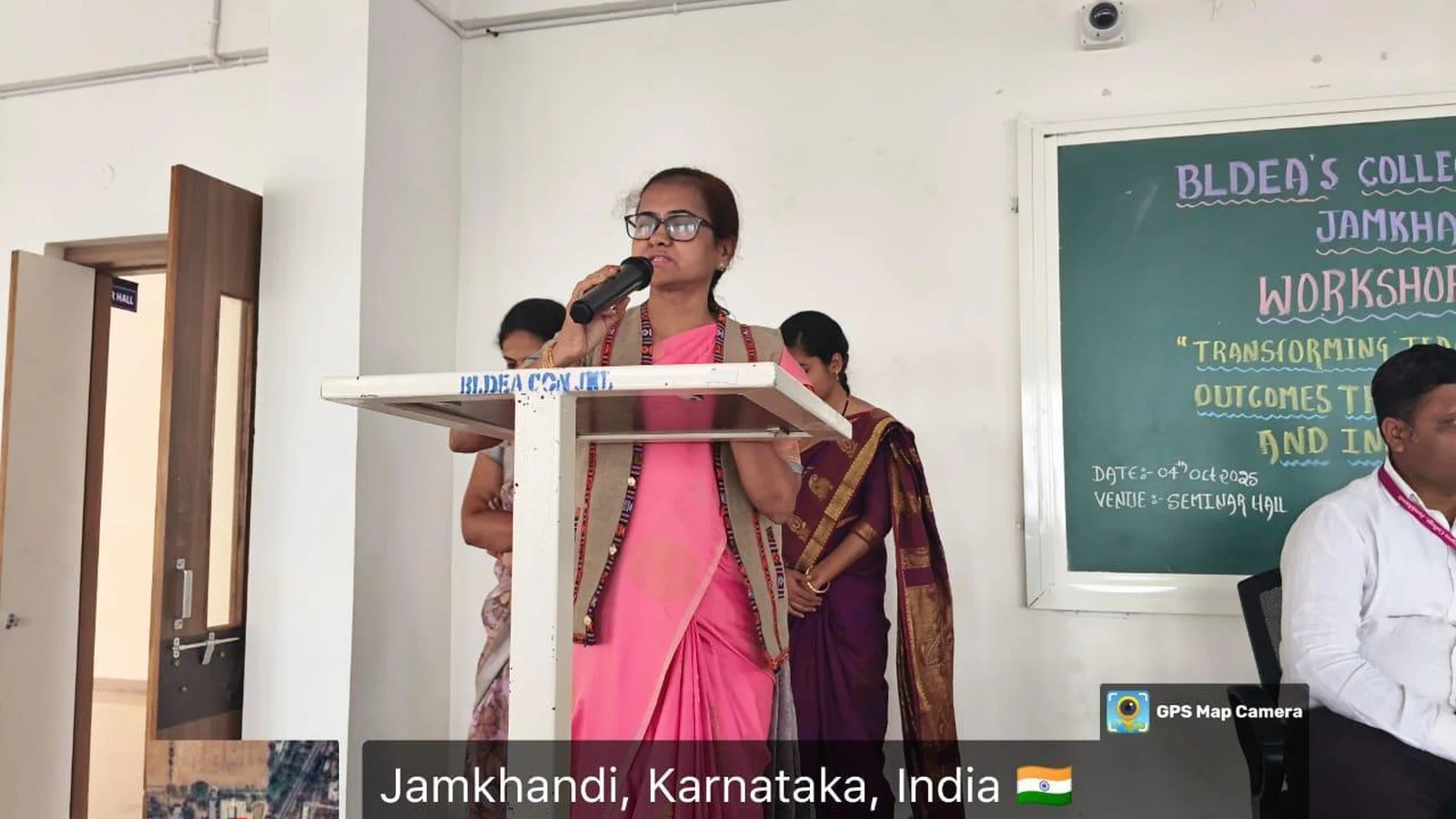 Faculty member addressing participants at podium during Workshop on Transforming Teaching Classroom Outcomes through Cognitive Levels and Innovative Strategies at BLDEA College of Nursing Jamkhandi October 4 2025