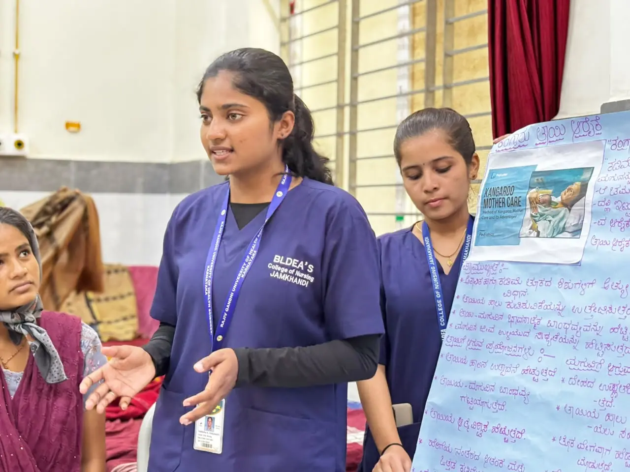 Nursing student explaining breastfeeding positioning and latching techniques to ANC PNC mothers using chart Government Hospital Jamkhandi