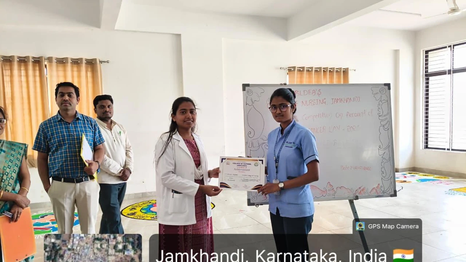 Mrs. Shivaleela Sarawad Assistant Professor BLDEA College of Nursing Jamkhandi presenting winner certificate to student at World Cancer Day Rangoli Competition felicitation on 6 February 2026